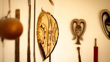 A wall with various historical artifacts including a shield, a sword, and a mask.