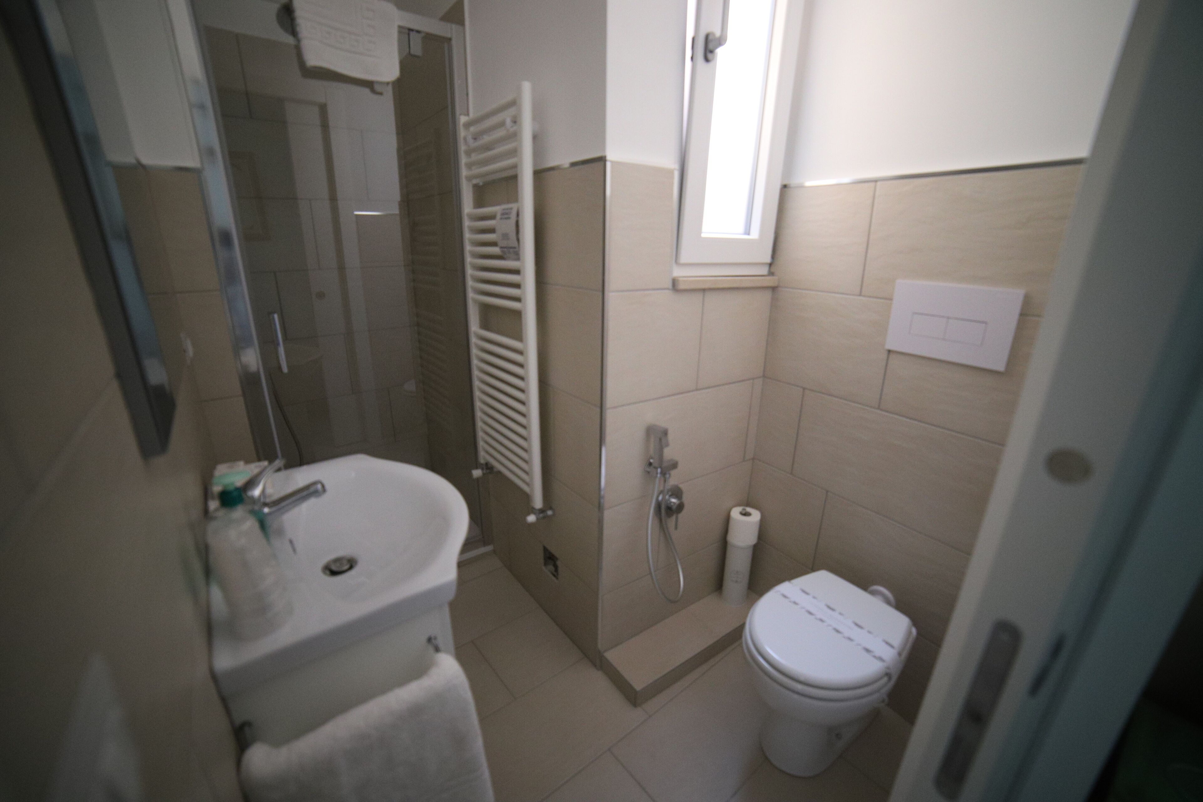 A bathroom with a sink, toilet, and shower.