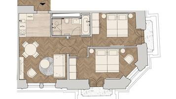 Plano de distribución de una habitación de hotel que incluye una cama, un escritorio, una silla, una mesita, un sofá, una zona de estar circular, un baño y una kitchenette.