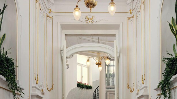 A grand staircase with ornate gold detailing and a chandelier. - R16 Residences Prague (Prague)