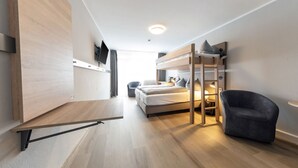 A modern, compact room with a bunk bed, a desk, and a chair. - Centerroom München City (Munich)