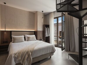 A modern bedroom with a large bed, a wooden headboard, and a built-in wardrobe. - Copal Simple Staying (Chania)
