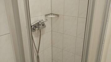 Shower, hair dryer, towels, toilet paper