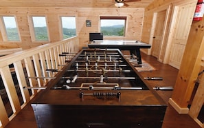 Enjoy a game of foosball in this room with a mountain view.