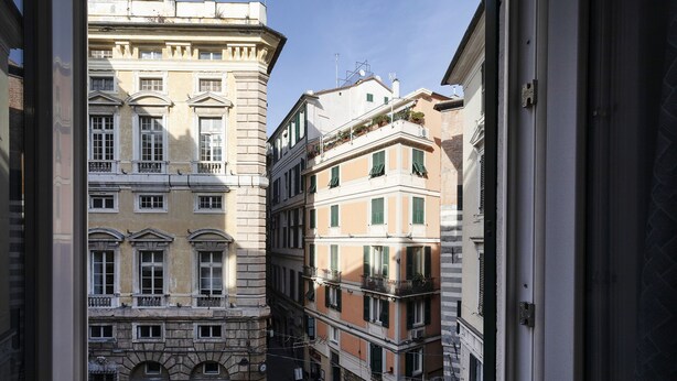 A narrow street between buildings with balconies and windows, suggesting a historic urban area. - Art and Comfort Near Lomellini Street by Wonderful Italy (Genoa)