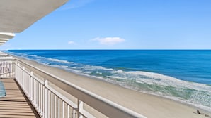 A balcony with a view of the beach and ocean. - Garden City Beach Oceanfront Condo 912 | Rising Tides Properties Rental (Murrells Inlet)