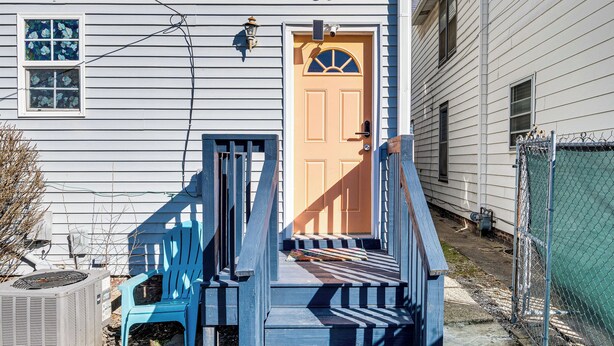 A house with a front door, a blue chair, and a small porch. - Pet-friendly Indianapolis Retreat Near City Center (Indianapolis)