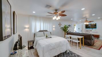 Laptop workspace, iron/ironing board, bed sheets