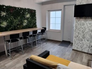 Cozy living space with a dining area, seating area, and large window.