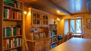 Enjoy a warm and inviting space with a dining table, bookshelf, and cabinet.