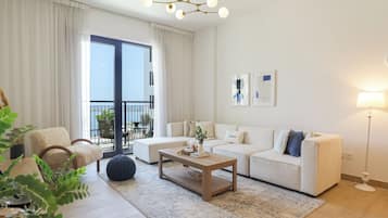 Comfort Apartment | Living area | 55-inch Smart TV with cable channels, Netflix, streaming services