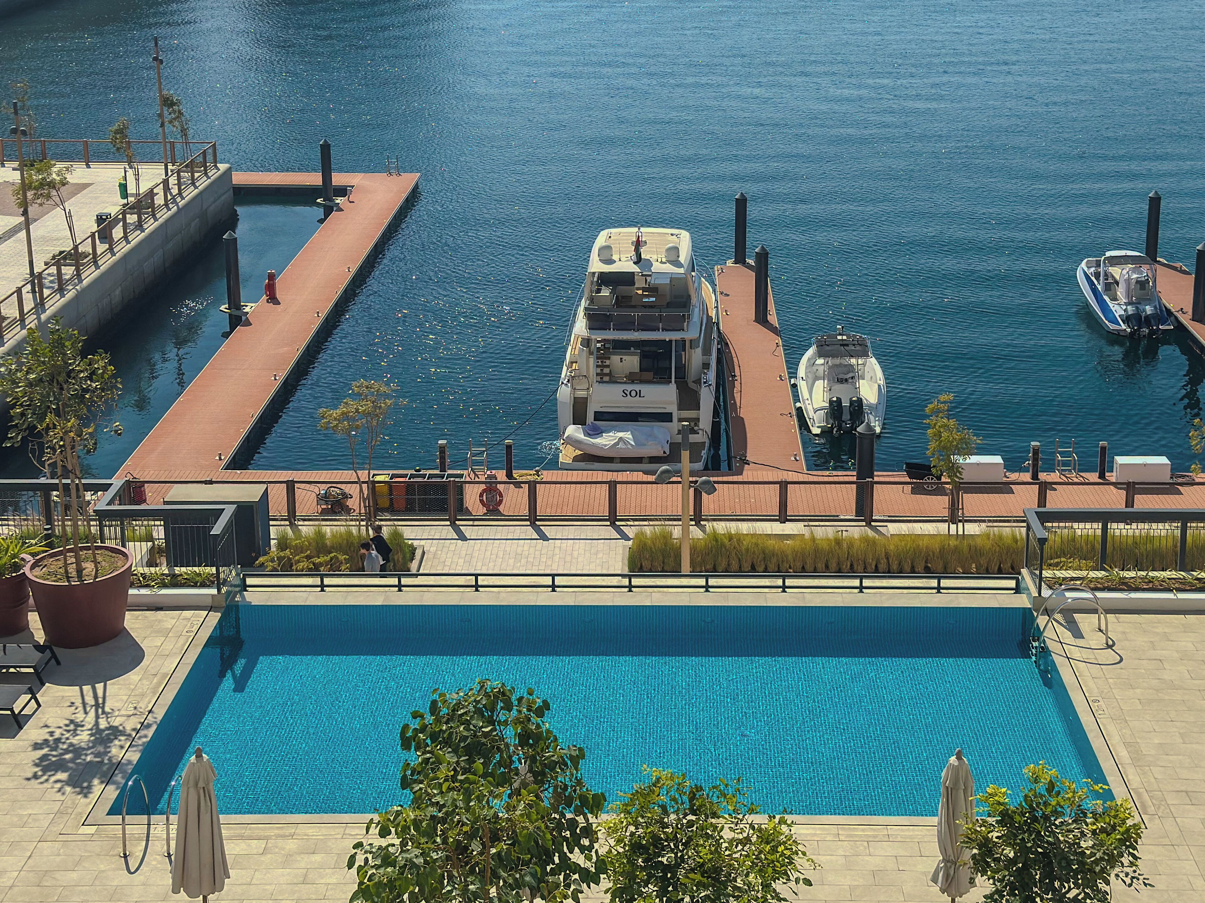 A swimming pool with a dock and a boat.