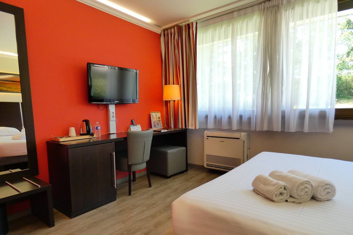 Premium bedding, desk, laptop workspace, blackout curtains