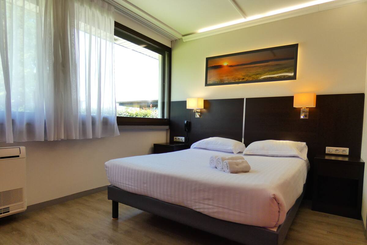 Premium bedding, desk, laptop workspace, blackout curtains