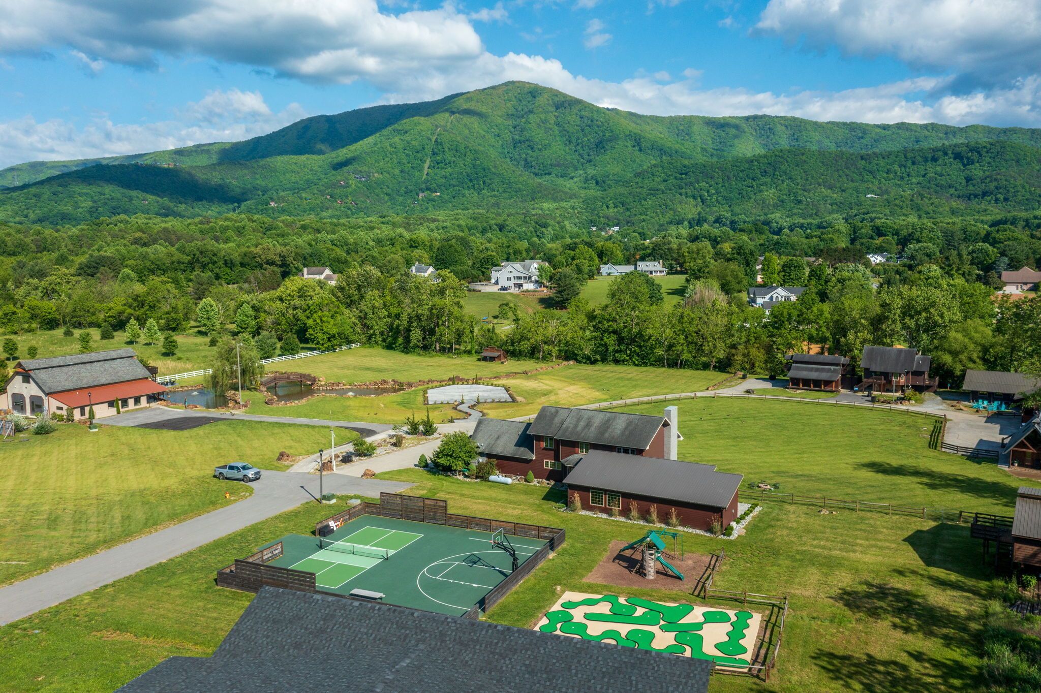 A residential area with houses, a basketball court, and a playground.