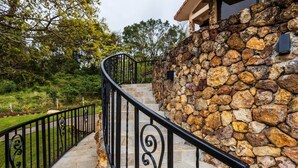 A stone staircase with black railings leading to a building with a stone facade. - House in Boquete, House in Boquete with king beds and hot tub (565749) (Alto Jaramillo)