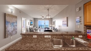 A modern kitchen with granite countertops, stainless steel sinks, and a built-in dishwasher.