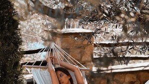 A hammock in a natural setting with stone walls and trees. - Chateau Fasel (Dajt)