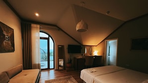 A cozy bedroom with a bed, a sofa, a desk, and a view of the outdoors. - Chateau Fasel (Dajt)