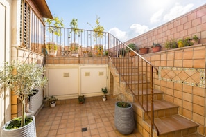 Enjoy an outdoor space with a patio, stairs, and lush greenery.
