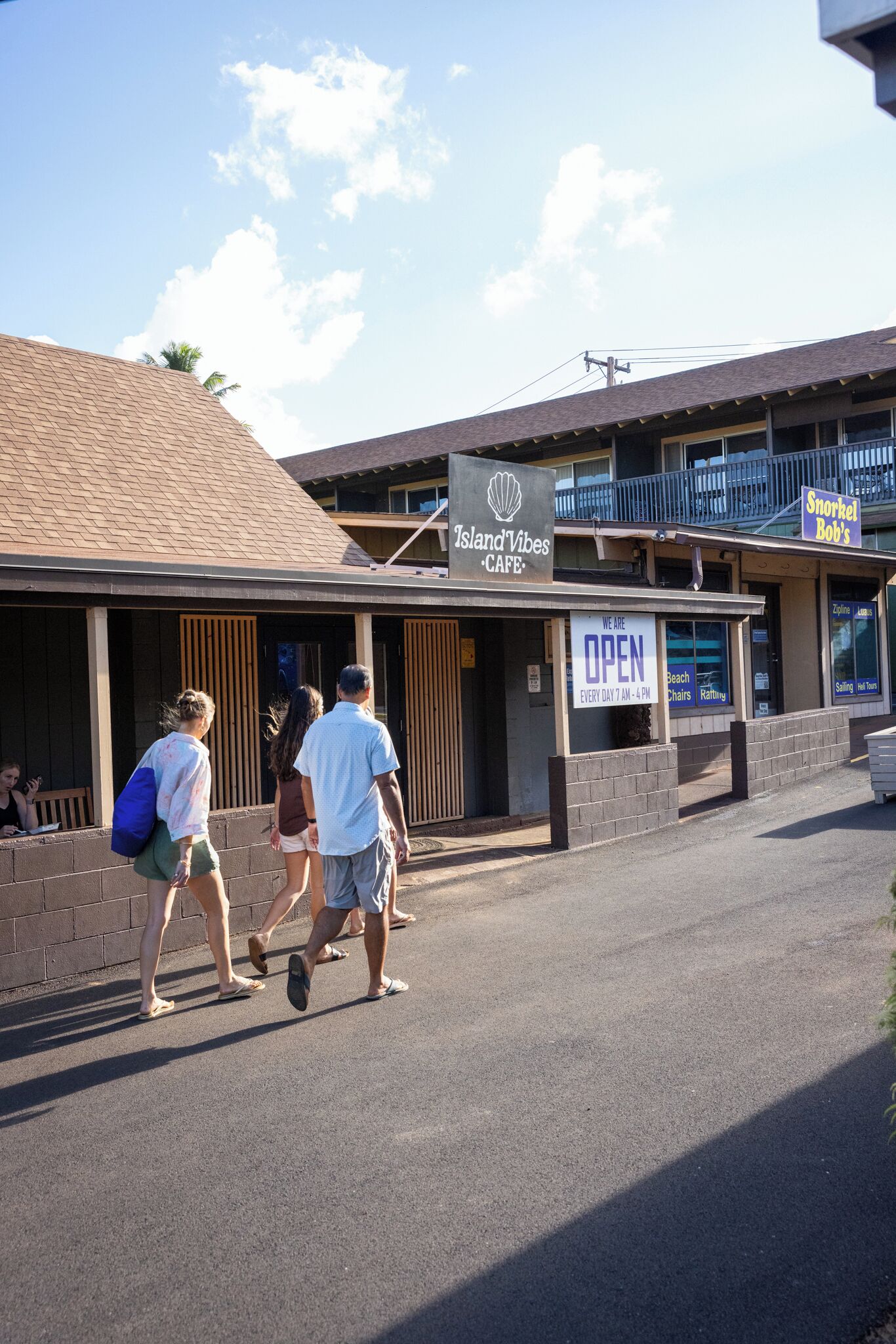 A building with a sign that reads "Island Vibes Cafe" and another sign that says "Snorkel Bob's."