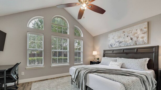A bedroom with a bed, a desk, and a ceiling fan. - Updated, Comfortable, and Quiet Space close to DFW International Airport! (Coppell)