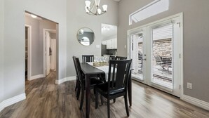 A dining area with a table, chairs, a chandelier, and a large mirror. - Updated, Comfortable, and Quiet Space close to DFW International Airport! (Coppell)