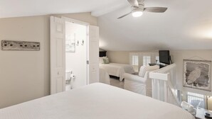 A bedroom with a large bed, a ceiling fan, and a view of a balcony. - 8 G Two Bedroom Condo (Miramar Beach)