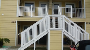 A two-story building with a central staircase and balconies on each floor. - 10e, Our Happy Place (Miramar Beach)