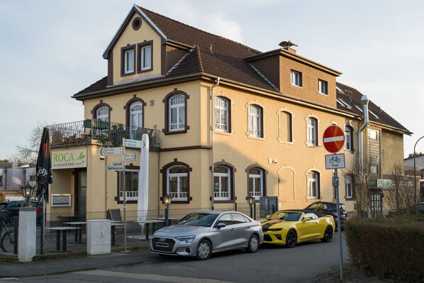 A building with a sign for 'ROCA Restaurant & Hotel'. - ROCA Restaurant & Hotel (Oberursel)