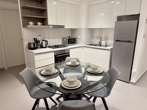 Enjoy cooking in this well-equipped kitchen with a gas stove, microwave, and refrigerator.