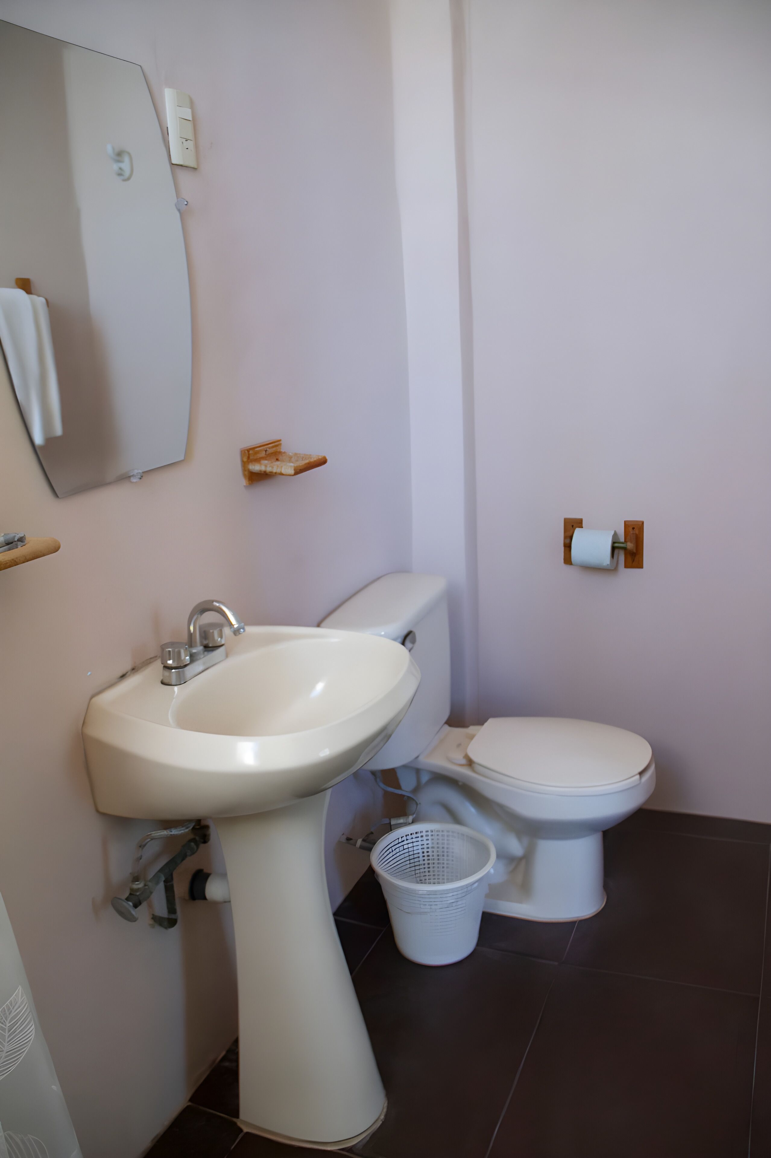 Ein Badezimmer mit Waschbecken, Toilette und Spiegel.