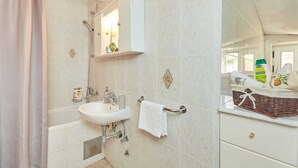 A bathroom with a sink, mirror, towel rack, and a shower curtain. - 7 Double room with private external bathroom in Villa Kate Dadić (Dubrovnik)