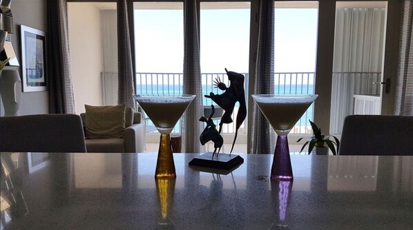 A dining table with two vases and a sculpture in the center. - Paradis - Luxurious Apartment with Ocean View and Balcony. (San Juan)