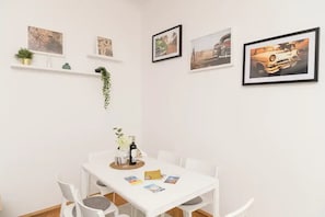 Cozy space with a dining table, four chairs, and framed artwork.