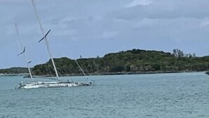 A sailboat on calm waters with a hilly landscape in the background. - Cozy Beach Condo (Rolletown)
