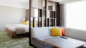 A hotel room with a bed, a sofa, a small table, and a partition. - Hotel Terrace The Garden Mito (Mito)