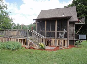 A wooden building with a balcony and a staircase leading to a deck. - Hooting Hollow Cabin formely known as "Living Water Cabin" (Cowen)