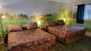 A room with two beds, each with floral-patterned bedding, a mural of a landscape on the wall, and a window with curtains. - La Collage Inn (Odessa)