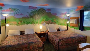 A room with two beds, each with a floral bedspread, a nightstand, a lamp, and a wall mural depicting a tropical scene. - La Collage Inn (Odessa)