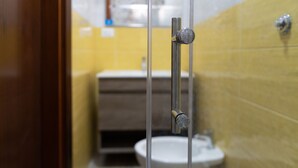 A bathroom with a toilet, sink, and shower area. - GG - Grow - Terrazza di Bellavista (Naples)