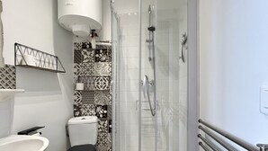 A bathroom with a toilet, sink, and shower. - Belle Échappée, Expérience Unique, Alliant Charme Historique, Commodités Moderne (Le Crotoy)