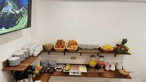 A breakfast buffet setup with various food items and beverages. - Inti Pacha Palace Machupicchu (Machu Picchu)