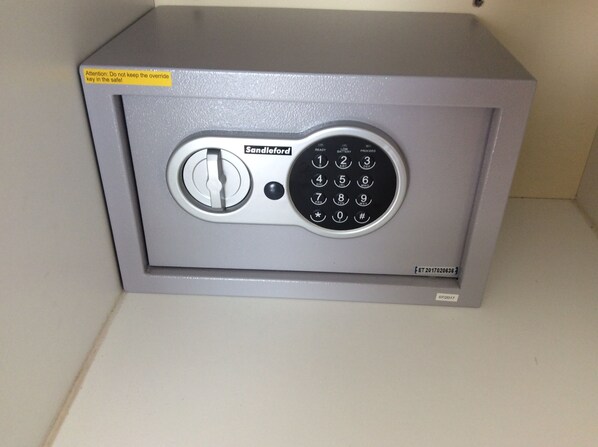 A gray safe with a combination dial and a keyhole.