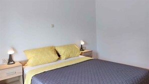 Cozy retreat with a single bed, two bedside tables, and soft lighting.