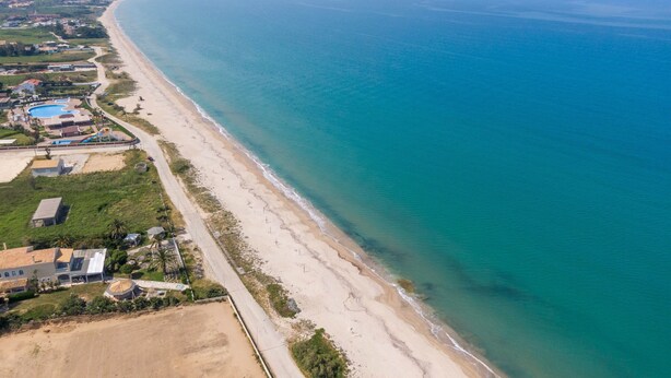 An aerial view of a coastal area with a beach, a swimming pool, and residential buildings. - Apartment 'Lotus 5' with Sea View, Wi-Fi and Air Conditioning (Corfu)