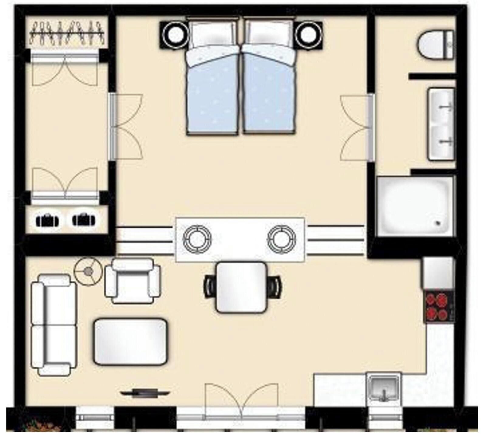 Ein Hotelzimmer mit einem Bett, zwei Sitzbereichen, einer Küchenzeile und einem Badezimmer.