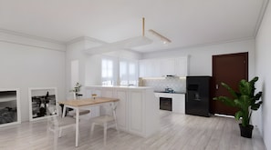 Una cocina moderna con armarios blancos, un refrigerador negro y un comedor con mesa y sillas de madera.