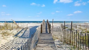 A wooden boardwalk leading to a beach with a clear sky. - WATERFRONT LOW DENSITY CONDO, BEACH ACCESS, INDOOR/OUTDOOR POOLS (Gulf Shores)