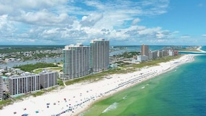 A coastal cityscape with high-rise hotels along a sandy beach. - BEACHFRONT, FAMILY FRIENDLY, LOW FLOOR, INDOOR/OUTDOOR POOL (Orange Beach)